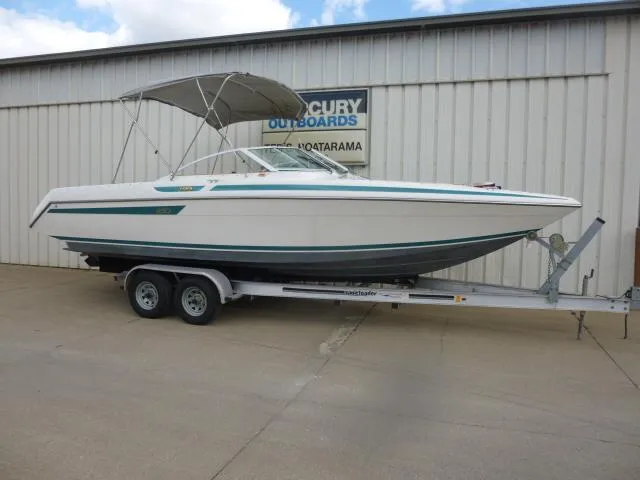 The Image of 1992 Tiara Sport 250 boat on trailer, parked outside a building. - 1