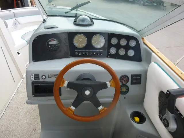 Slide: The Image of 1992 Tiara Sport 250 boat dashboard with wooden steering wheel and instrument panel. - 13
