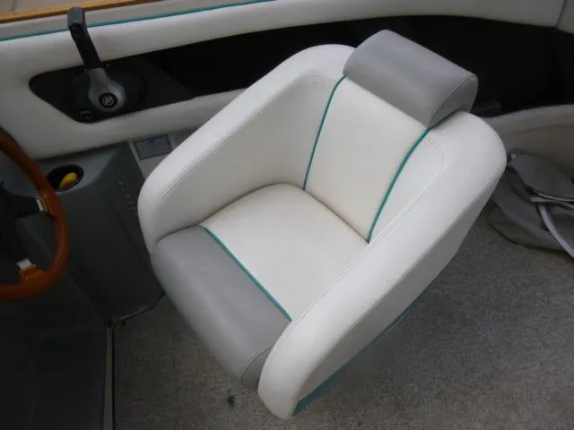Slide: The Image of Captain's chair in a 1992 Tiara Sport 250 boat, featuring white and gray upholstery. - 17