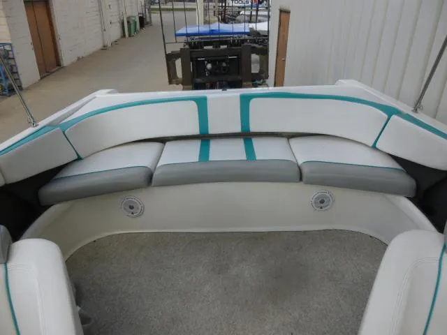 Slide: The Image of 1992 Tiara Sport 250 boat interior with white and teal seating. - 18