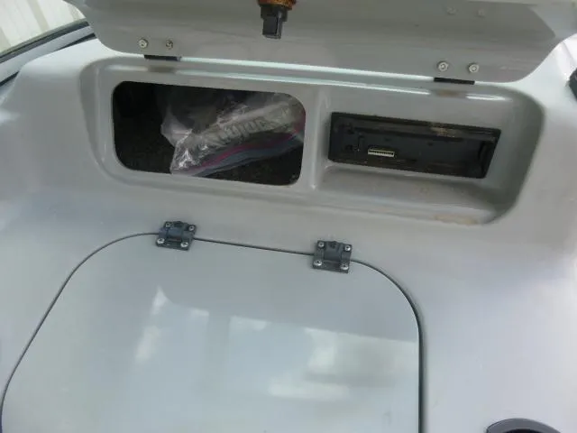 Slide: The Image of 1992 Tiara Sport 250 storage compartment with open lid and visible interior. - 19