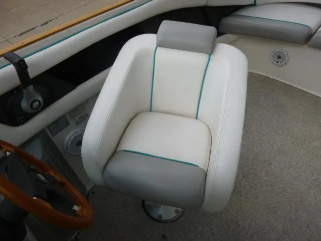 Slide: The Image of Tiara Sport 250 boat interior, 1992 model, featuring a cushioned captain's chair and steering wheel. - 24