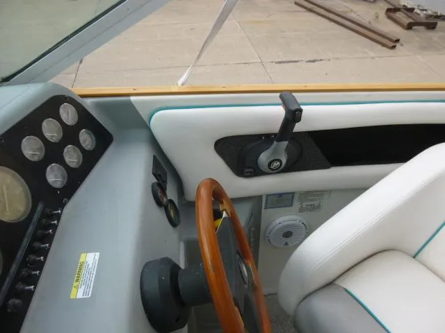 Slide: The Image of 1992 Tiara Sport 250 boat cockpit with steering wheel and control panel. - 25
