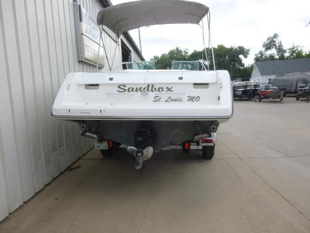 Slide: The Image of 1992 Tiara Sport 250 boat named "Sandbox" in St. Louis, MO, parked near a building. - 6