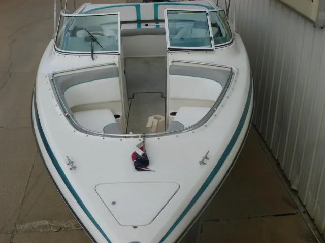 Slide: The Image of 1992 Tiara Sport 250 boat with open bow and windshield, docked beside a building. - 9