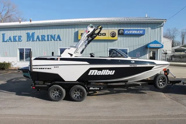 Slide: The Image of 2024 Malibu 20 VTX boat on trailer outside Lake Marina. - 1