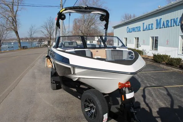 Slide: The Image of 2024 Malibu 20 VTX boat at Coldwater Lake Marina, parked on a trailer. - 2
