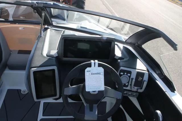 Slide: The Image of 2024 Malibu 20 VTX boat dashboard with modern controls and touchscreen displays. - 7