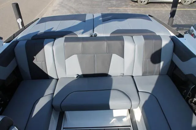 Slide: The Image of 2024 Malibu 20 VTX boat interior with gray and black seating. - 9