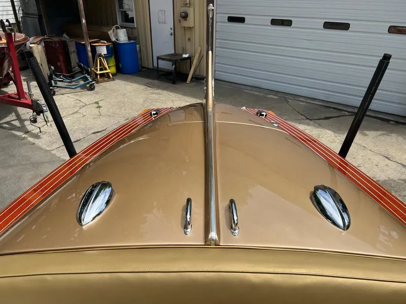 Slide: The Image of 1955 Chris-Craft Cobra 21 boat with sleek gold finish and chrome details. - 10