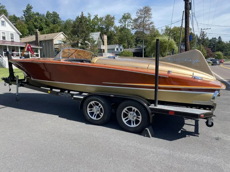Slide: The Image of 1955 Chris-Craft Cobra 21 boat on trailer, showcasing classic design and vintage elegance. - 14