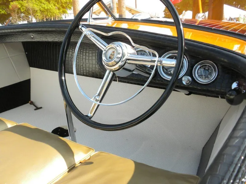 Slide: The Image of 1955 Chris-Craft Cobra 21 boat interior with vintage steering wheel and dashboard gauges. - 19