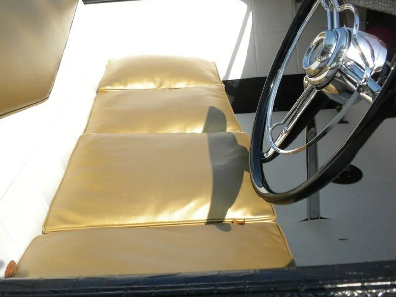 Slide: The Image of 1955 Chris-Craft Cobra 21 interior with gold seats and classic steering wheel. - 27