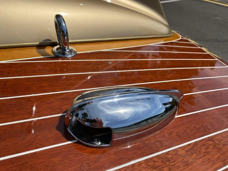 Slide: The Image of 1955 Chris-Craft Cobra 21 boat with polished chrome details and wooden deck. - 31