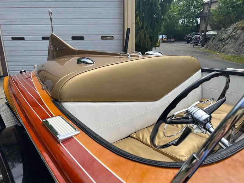 Slide: The Image of 1955 Chris-Craft Cobra 21 boat interior with vintage steering wheel and wooden deck. - 4