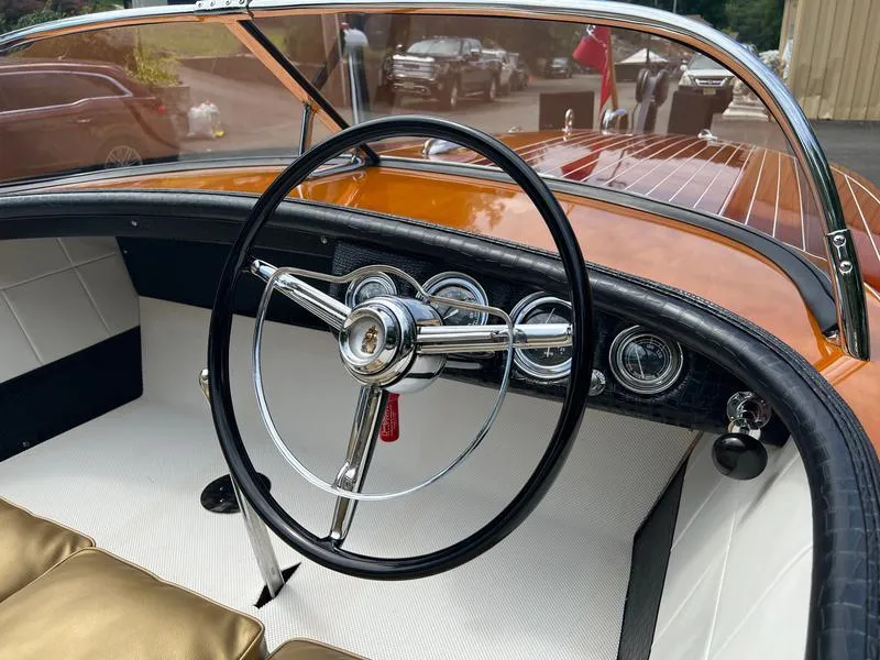 Slide: The Image of 1955 Chris-Craft Cobra 21 boat interior with classic steering wheel and dashboard. - 5