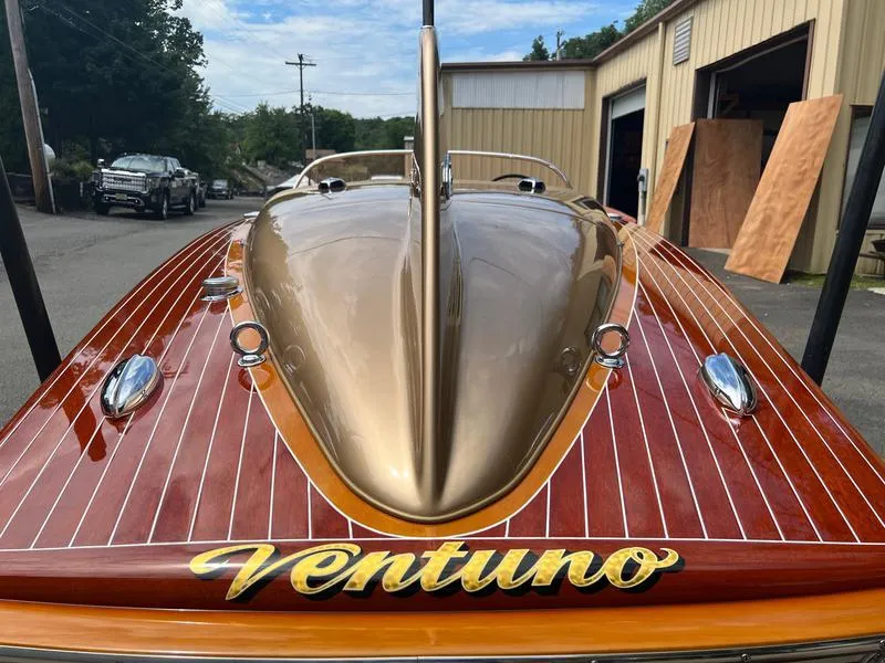 Slide: The Image of 1955 Chris-Craft Cobra 21 boat with sleek wooden finish and "Ventuno" nameplate. - 8