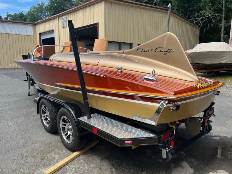 Slide: The Image of 1955 Chris-Craft Cobra 21 boat on trailer, showcasing classic design and sleek lines. - 9