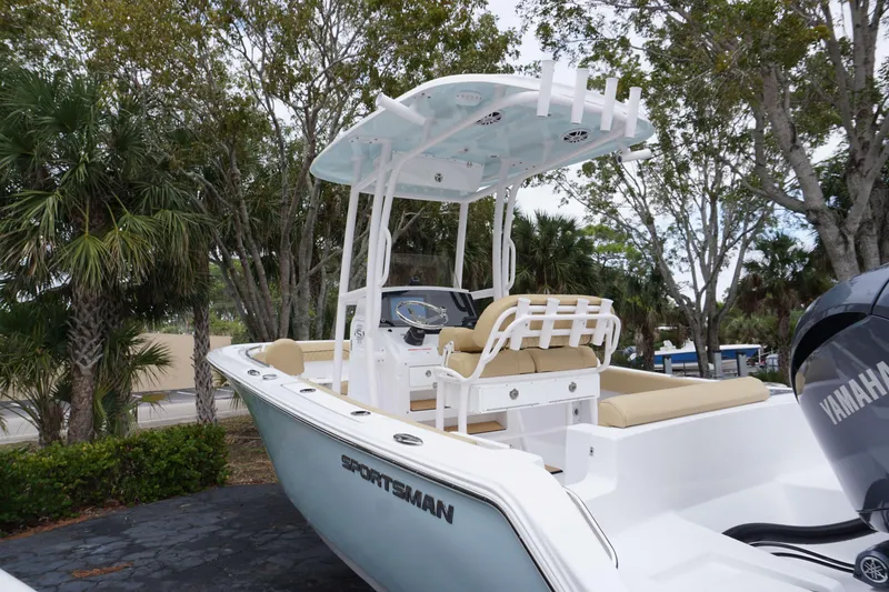 Slide: The Image of 2024 Sportsman 212 Open boat with Yamaha engine, docked near palm trees. - 22