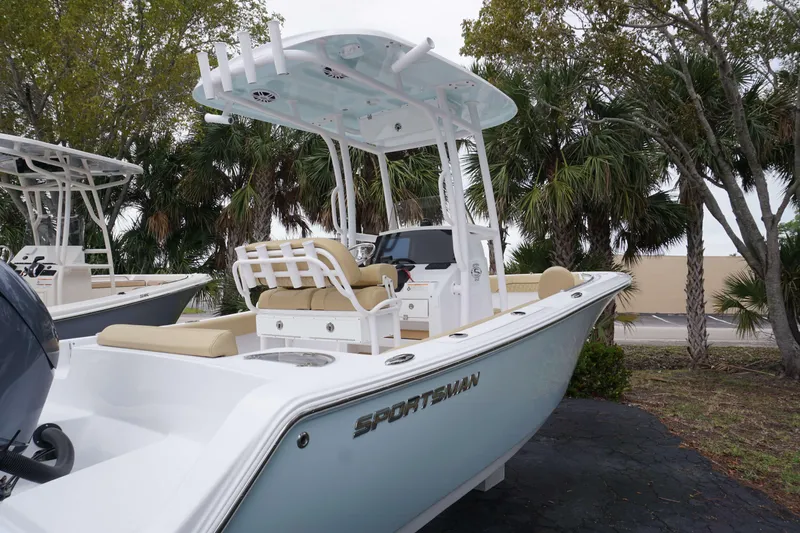 Slide: The Image of 2024 Sportsman 212 Open boat with T-top and seating, parked outdoors. - 23