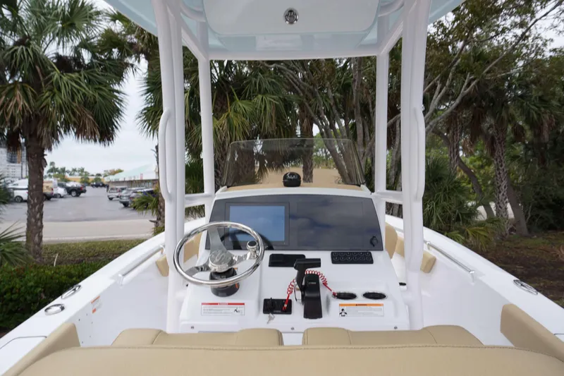 Slide: The Image of 2024 Sportsman 212 Open boat dashboard with steering wheel and electronic controls. - 26