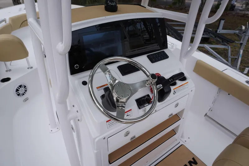 Slide: The Image of 2024 Sportsman 212 Open boat dashboard with steering wheel and control panel. - 27