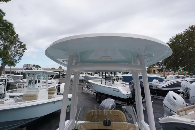 Slide: The Image of 2024 Sportsman 212 Open boat at a marina with other boats. - 28