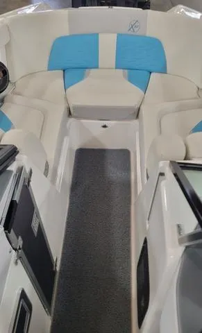 Slide: The Image of 2019 MasterCraft X22 boat interior with blue and white seating. - 11