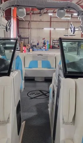 Slide: The Image of 2019 MasterCraft X22 boat interior in a warehouse setting. - 12