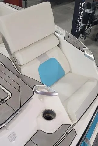 Slide: The Image of 2019 MasterCraft X22 boat interior with white and blue seating. - 16
