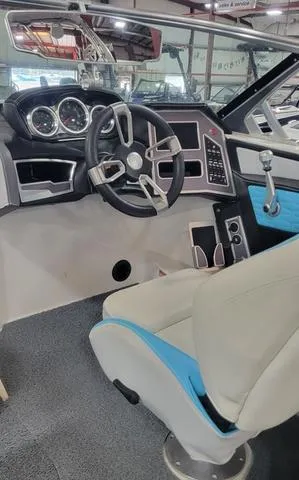 Slide: The Image of 2019 MasterCraft X22 boat interior with modern dashboard and steering wheel. - 7