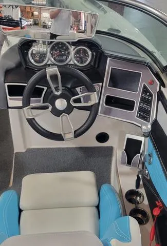 Slide: The Image of 2019 MasterCraft X22 boat dashboard with steering wheel and control panel. - 8
