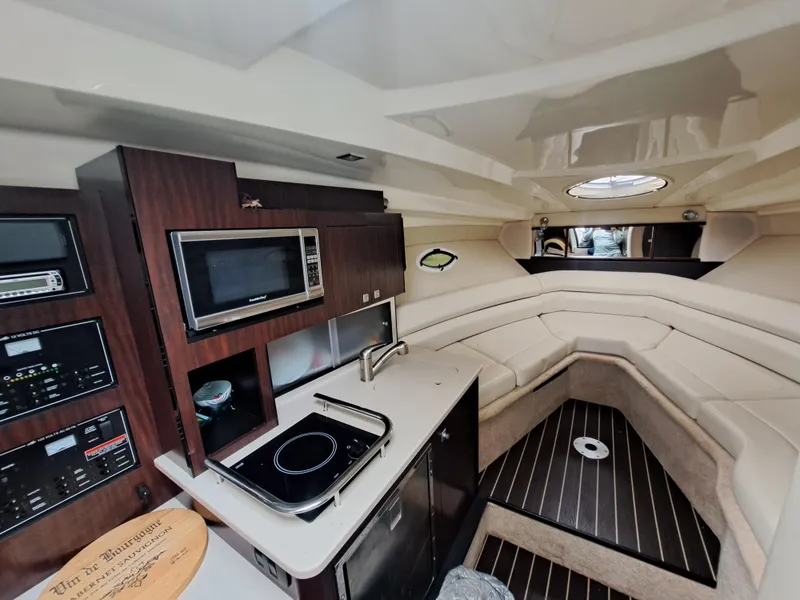 Slide: The Image of Interior of 2015 Monterey 295 Sport Yacht with kitchenette and seating area. - 14