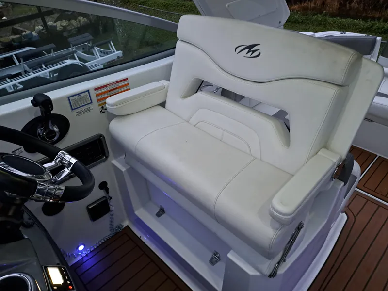 Slide: The Image of Captain's seat of a 2015 Monterey 295 Sport Yacht with white upholstery. - 16