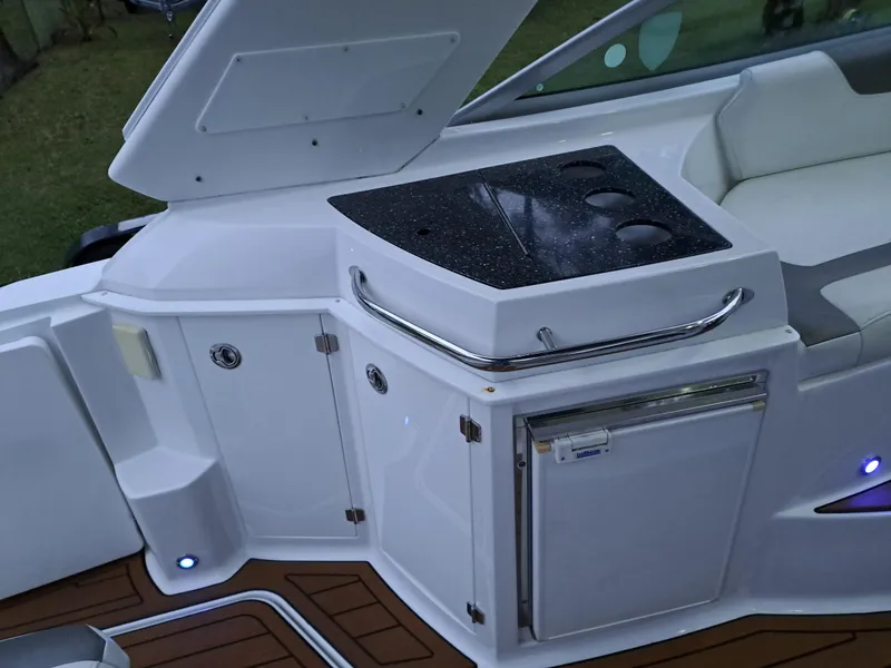Slide: The Image of 2015 Monterey 295 Sport Yacht kitchenette with sink, storage, and mini-fridge. - 20