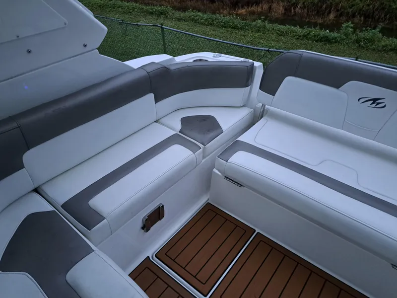 Slide: The Image of 2015 Monterey 295 Sport Yacht interior seating with white and gray upholstery. - 22