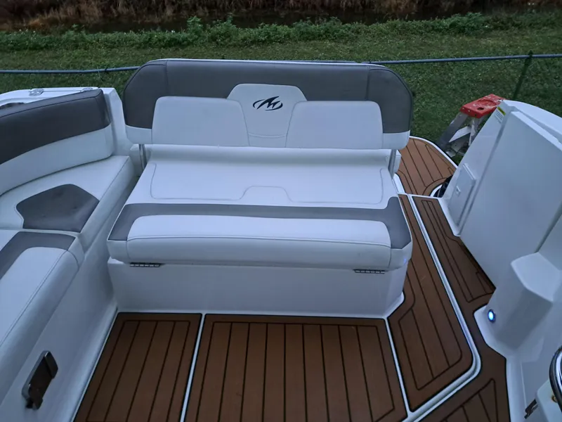 Slide: The Image of Monterey 295 Sport Yacht 2015, white and gray seating, teak deck, outdoor view. - 23