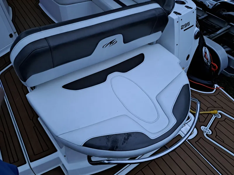 Slide: The Image of 2015 Monterey 295 Sport Yacht seating area with white and black upholstery. - 25