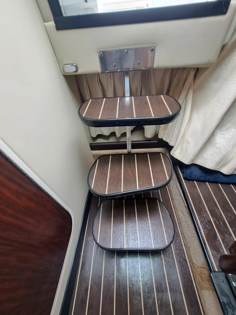 Slide: The Image of 2015 Monterey 295 Sport Yacht interior steps with wooden finish. - 28