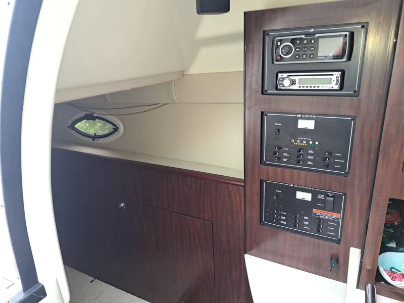 Slide: The Image of Interior cabin of a 2015 Monterey 295 Sport Yacht with control panels and audio system. - 29