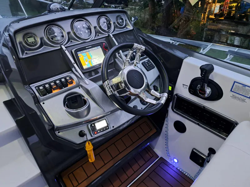 Slide: The Image of 2015 Monterey 295 Sport Yacht helm with navigation system and controls. - 5