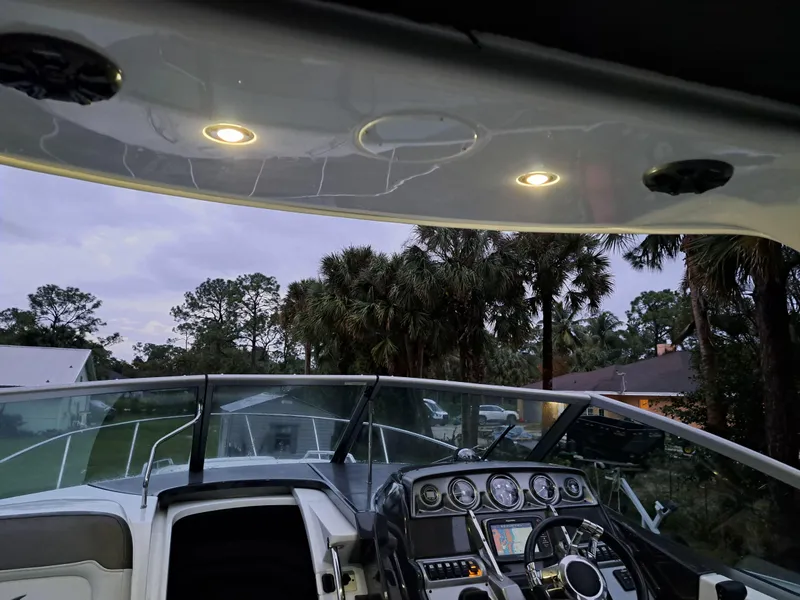 Slide: The Image of Cockpit view of 2015 Monterey 295 Sport Yacht at dusk with illuminated dashboard. - 7