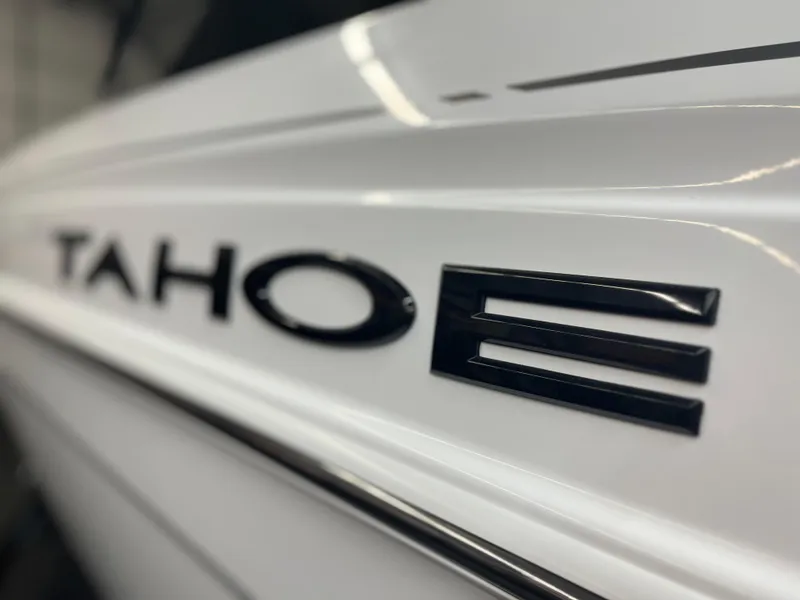 Slide: The Image of Close-up of 2024 Tahoe T21 model nameplate on white surface. - 2