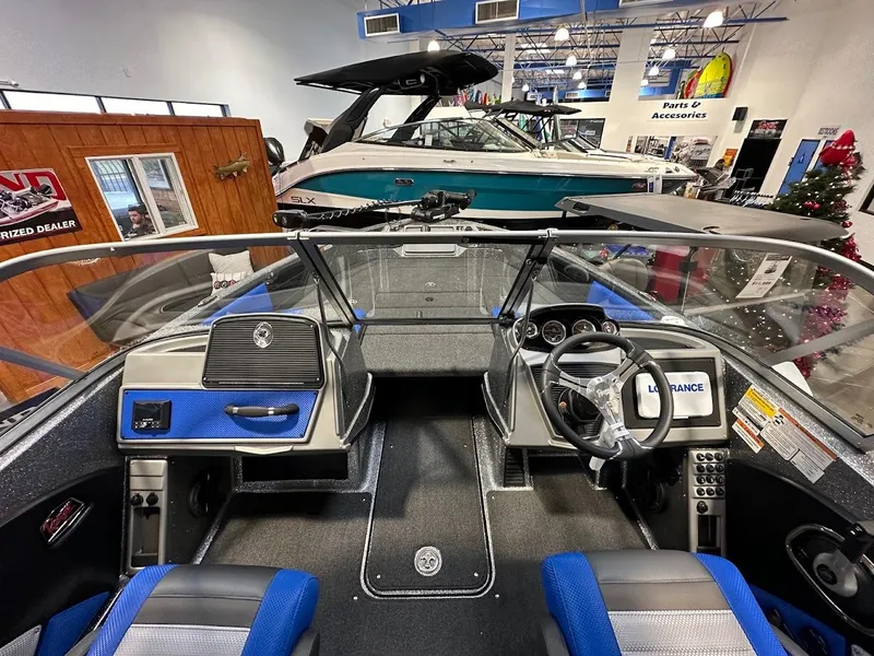 Slide: The Image of 2024 Ranger 1850MS boat interior with blue accents in showroom. - 10