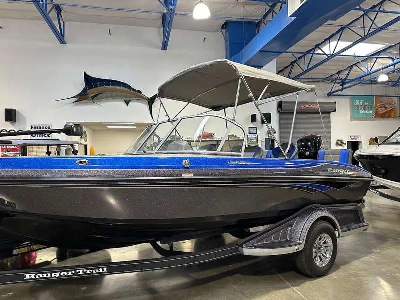 Slide: The Image of 2024 Ranger 1850MS boat with canopy on display in showroom. - 2
