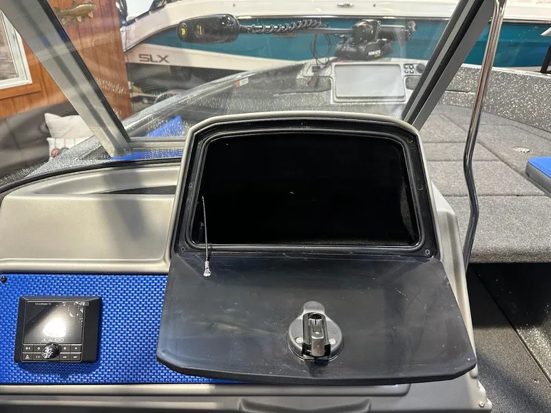 Slide: The Image of 2024 Ranger 1850MS boat dashboard with open storage compartment and control panel. - 24