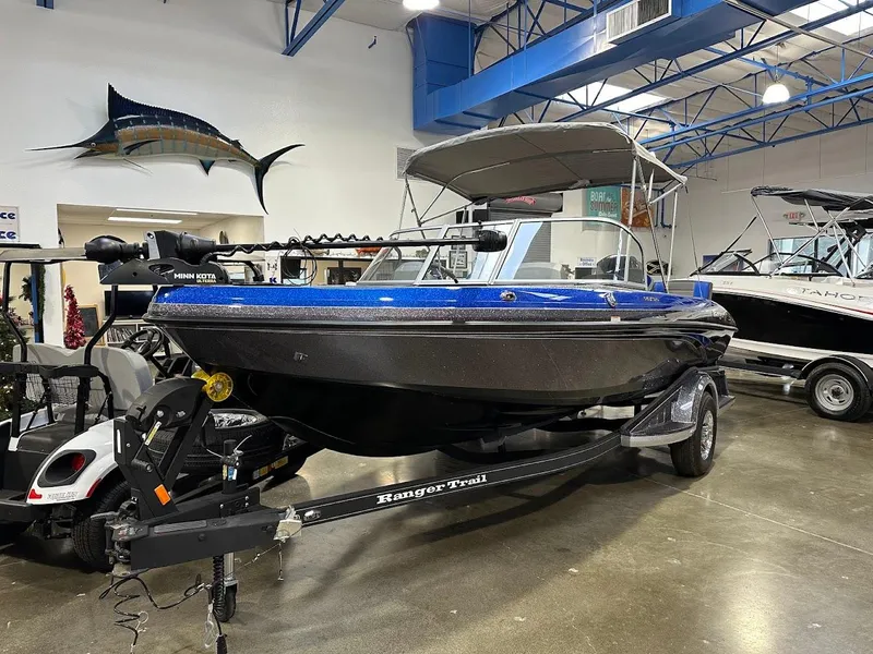 Slide: The Image of 2024 Ranger 1850MS boat in showroom, blue and black design, on trailer. - 3