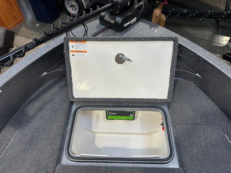 Slide: The Image of 2024 Ranger 1850MS boat storage compartment with open lid and visible battery. - 30