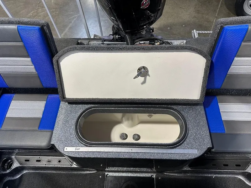 Slide: The Image of 2024 Ranger 1850MS boat interior with open storage compartment and blue seating. - 33