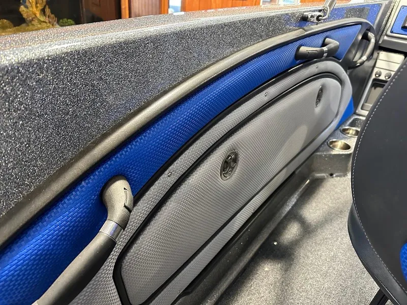 Slide: The Image of 2024 Ranger 1850MS boat interior with blue and gray accents, featuring storage compartments. - 34